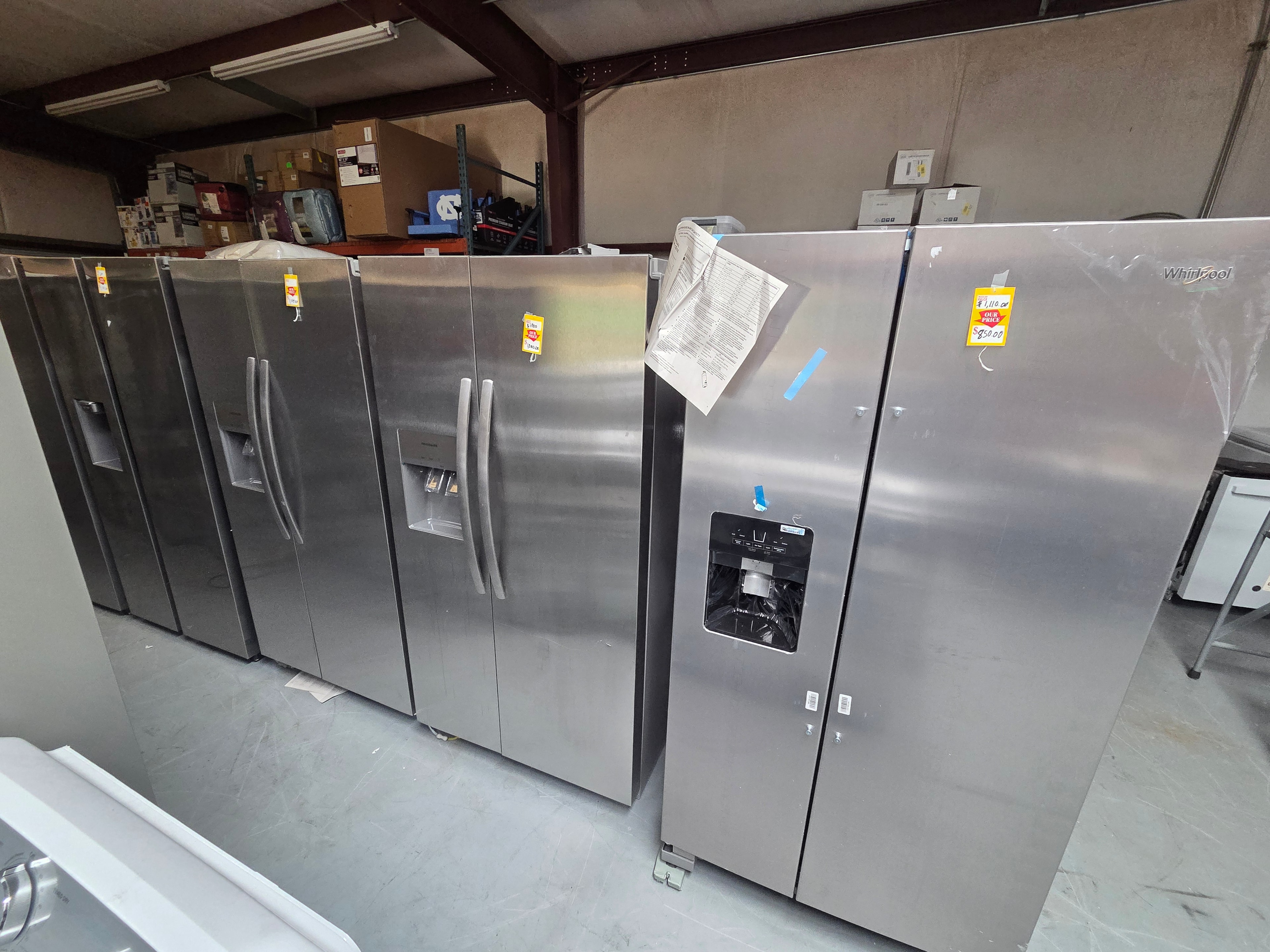Neal Liquidations warehouse — stainless steel refrigerators display