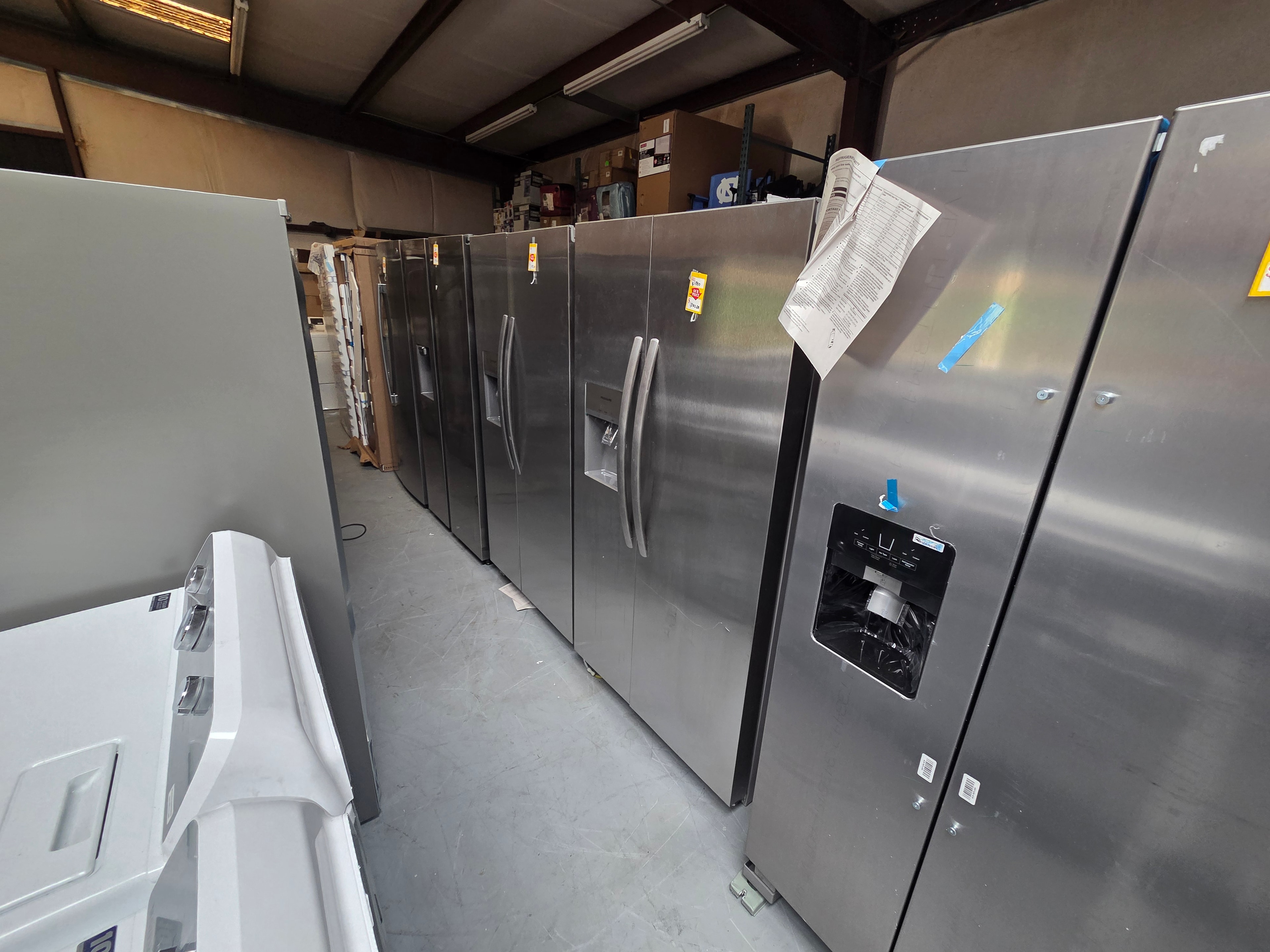 Neal Liquidations warehouse — stainless steel refrigerators