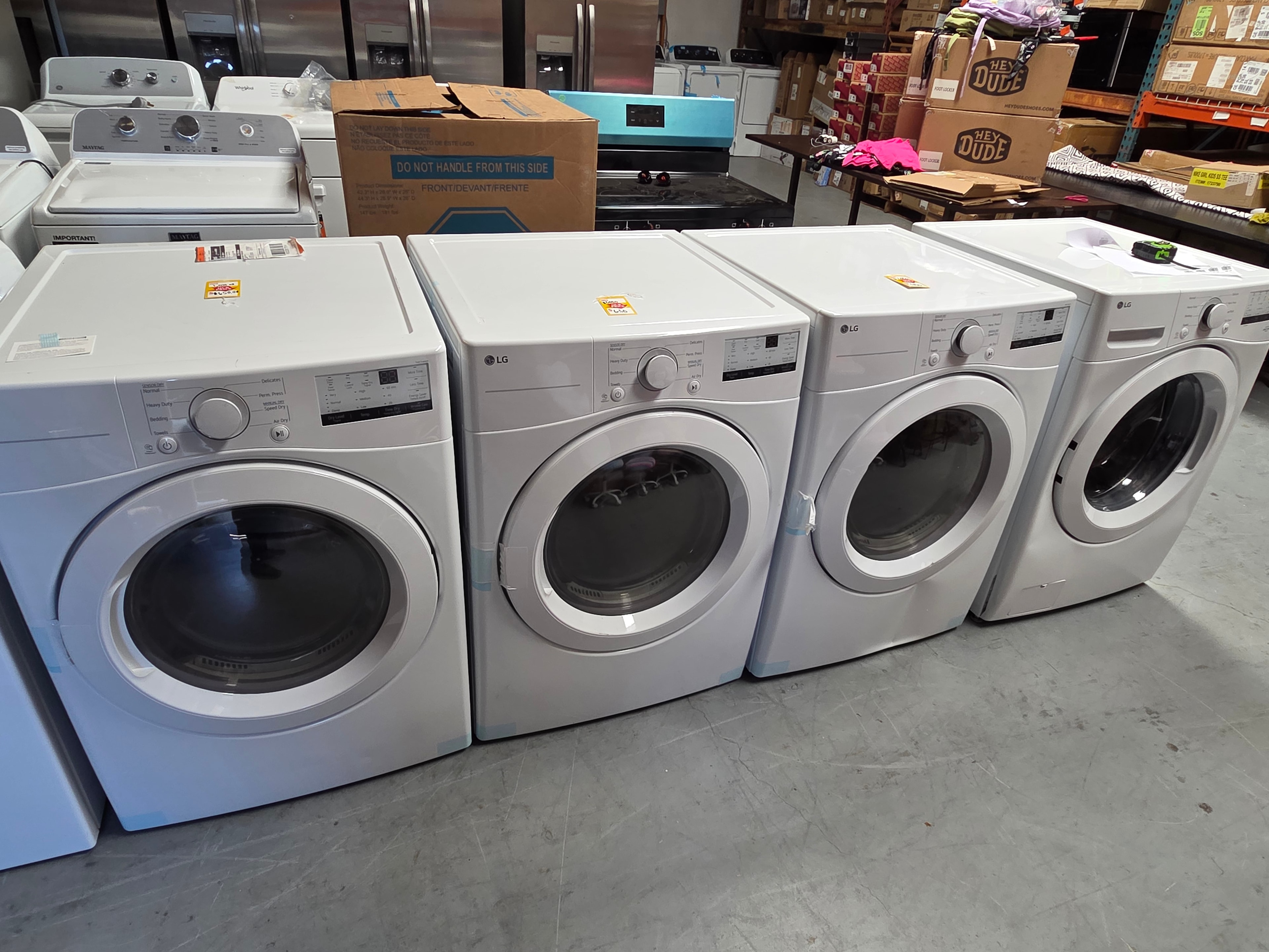 Neal Liquidations warehouse — row of front load dryers
