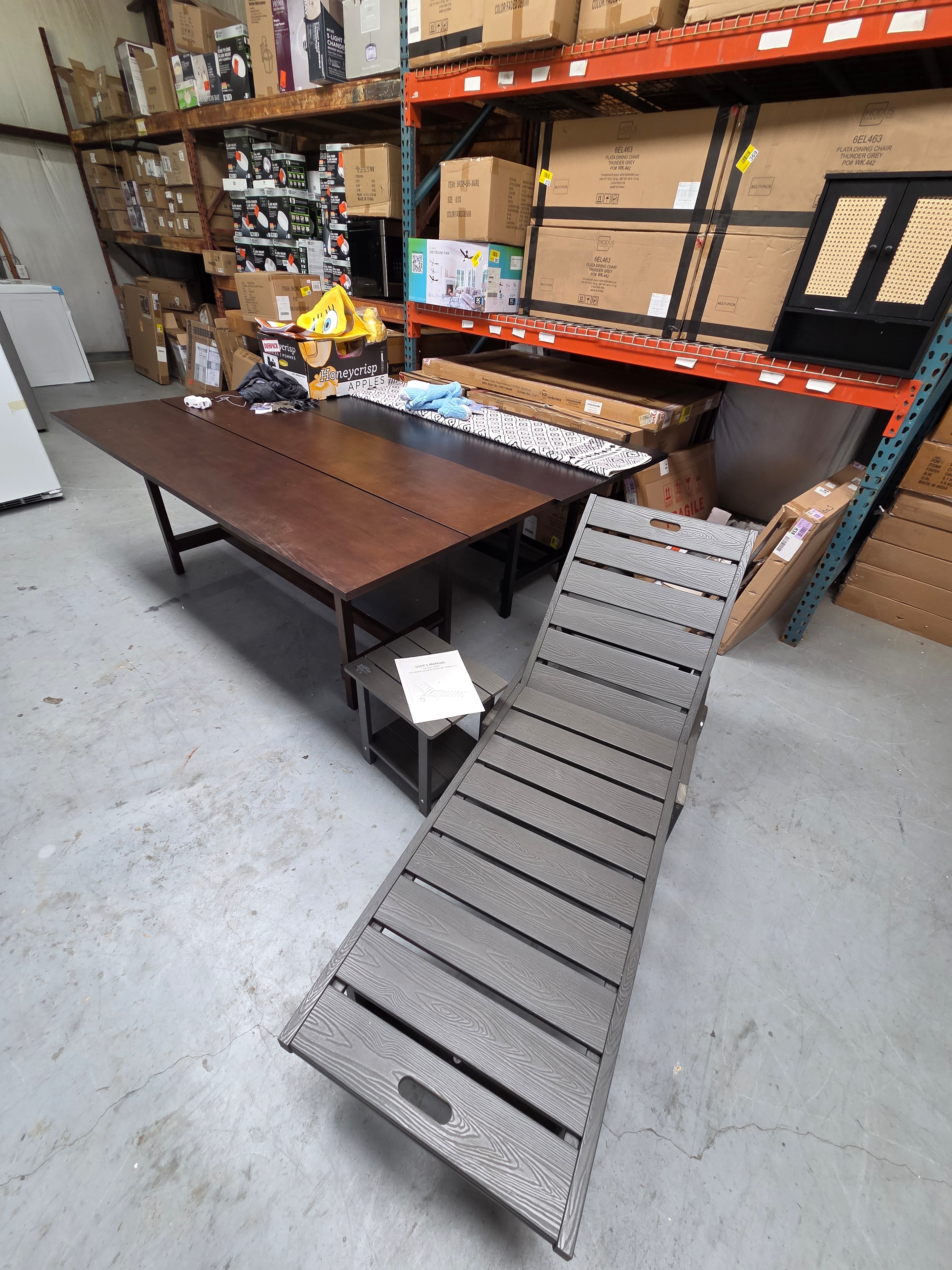 Outdoor patio furniture and tables on warehouse floor